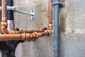 Pipes inside a home, gradually beginning to rust.