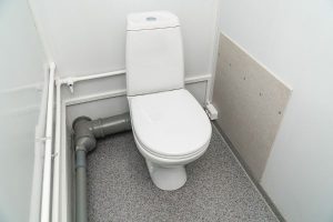 picture of white-colored toilet with the lid closed.